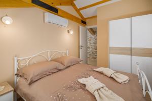 a bedroom with a bed with two towels on it at Villa Ivea in Višnjan +18 photos