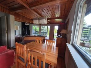 a kitchen and dining room with a wooden table and chairs at Dom Letniskowy, Siła in Sila