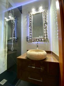 a bathroom with a sink and a mirror at Grand Plaza Vega in Burgos