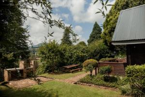 a garden with a picnic table and a bench at Viewpoint - Cabin 4 in Haenertsburg