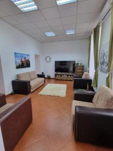 a living room with couches and a flat screen tv at Central Park Apartments in Cluj-Napoca