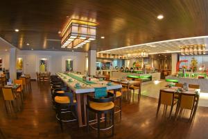 ein Speisesaal mit Tischen und Stühlen und ein Restaurant in der Unterkunft HARRIS Hotel & Conventions Malang in Malang