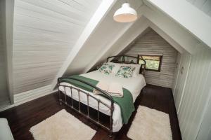 a bedroom with a bed in a attic at Viewpoint - Cabin 4 in Haenertsburg