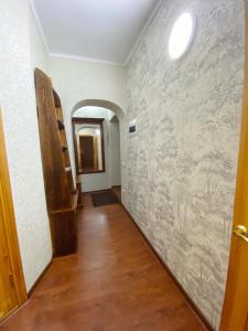 un corridoio con un muro con un dipinto sopra di Апартаменты аэропорт a Almaty