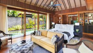 a bedroom with a bed and a couch at Hotel Indigo Bali Seminyak Beach by IHG in Seminyak