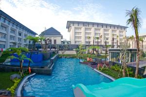 eine Wasserrutsche in einem Resort mit Gebäuden in der Unterkunft HARRIS Hotel & Conventions Malang in Malang