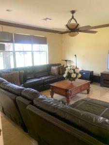 a living room with a leather couch and a coffee table at Relaxation Zone in West Palm Beach