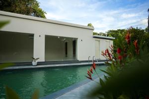 a house with a swimming pool in front of it at Valluvanad Residency in Perintalmanna