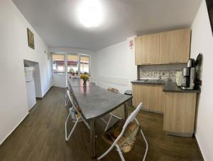 a kitchen with a table and chairs in a room at Casa Anne Marie in Sinaia