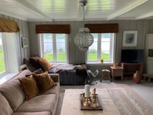a living room with a couch and a table at Steinsvoll Gård in Vang I Valdres