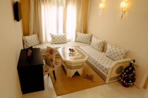 een woonkamer met een bank en een tafel bij Hotel La Luna in Beni Mellal