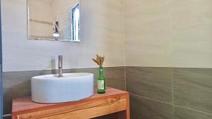 a bathroom with a sink and a bottle on a table at Chunlii Homestay in Ke Ga +78 photos