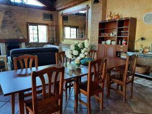 a dining room with a wooden table and chairs at Lhamo Mandala House in Pontevedra