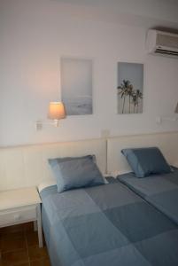 a bedroom with two beds and a table and a lamp at Apartamento IGUAZU in Playa del Ingles +35 photos