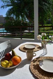 a table with a plate of fruit on top of it at Apartamento IGUAZU in Playa del Ingles