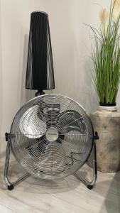 a metal table with a lamp and two potted plants at Apartment Hospodárska in Trnava