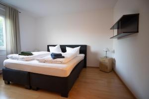 a bedroom with a large bed with white pillows at Haus Hotel Inter in Buxtehude