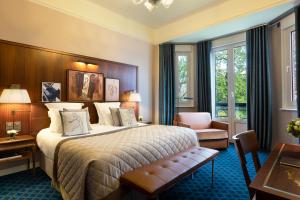 a hotel room with a bed and a desk at Hôtel Barrière Le Westminster in Le Touquet-Paris-Plage