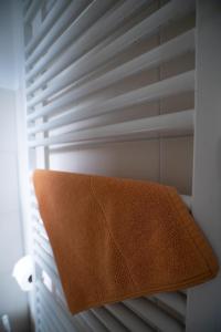 a brown pillow sitting on top of a shelf with a window at Haus Hotel Inter in Buxtehude