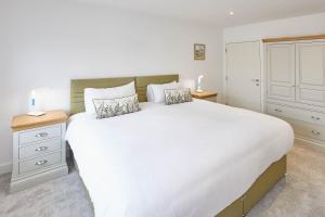 a bedroom with a large white bed with two pillows at Host & Stay - Even Keel in Whitby