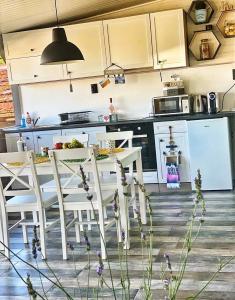 a kitchen with a table and chairs in a kitchen at La Veranda Sinemorets in Sinemorets