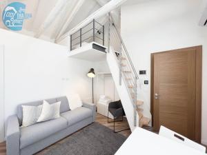 a living room with a couch and a staircase at Basovizza 3 Nicole Tirabora Short Rent in Villa Opicina