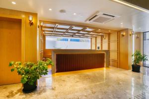 a meeting room with a projection screen and plants at The Vincent inn in Bhopal