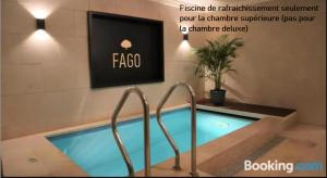 a swimming pool in a building with a sign at B&B Fago in Bruges