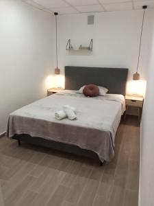 a bedroom with a large bed with two towels on it at Apartman Vranac in Vela Luka