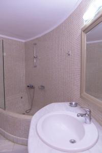 a bathroom with a white sink and a shower at Elizabeth Suites in Kato Daratso