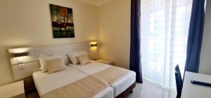 Postel nebo postele na pokoji v ubytování ESPERANCE HOTEL
