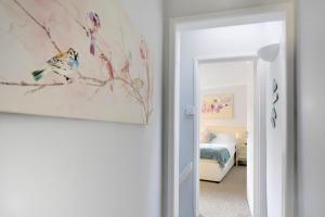 a bedroom with a bed and a painting on the wall at The Retreat in Lyme Regis