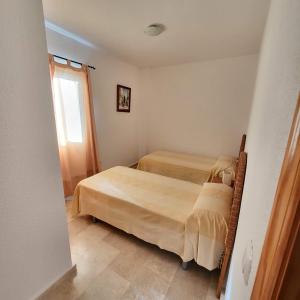 Posteľ alebo postele v izbe v ubytovaní Casa amplia adosada al lado de la playa