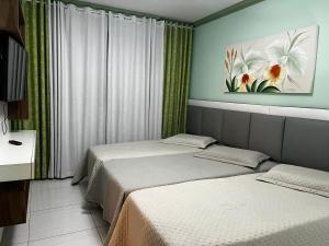 Postelja oz. postelje v sobi nastanitve Apartamento de 3 quartos amplos na praia Pitangueiras, Guaruja