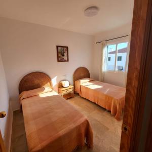 Posteľ alebo postele v izbe v ubytovaní Casa amplia adosada al lado de la playa
