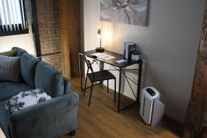 a living room with a table with a chair and a couch at Luxéry Stay Chicago - Themed Units! Close to Downtown, McCormick Place & Wintrust Arena in Chicago