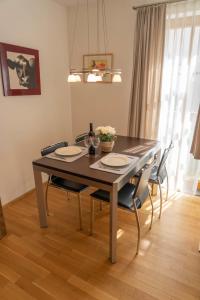 a dining room table with four chairs and a dining room table at Anna 1 by SMR Rauris Apartments - inc Spa and National Summercard - near Gondola in Rauris