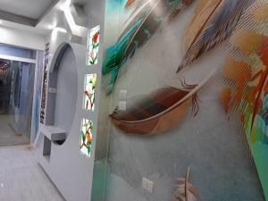 a room with a painting of a boat on the wall at Alhambra 2 rooms Apartment in Hurghada