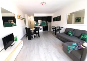 a living room with a couch and a kitchen at Mareverde Elisa, 1 bedroom & Wifi Free in Adeje