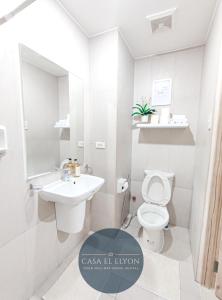 a white bathroom with a toilet and a sink at White Nordic Fully-Furnished Studio at INSPIRIA in Davao City
