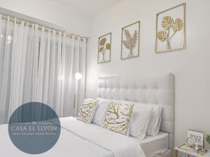 a bedroom with a white bed with pillows on it at White Nordic Fully-Furnished Studio at INSPIRIA in Davao City