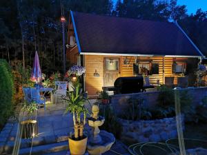 a small house with a patio at night at Ferienhaus mit mediterraner Terrasse in Müllrose