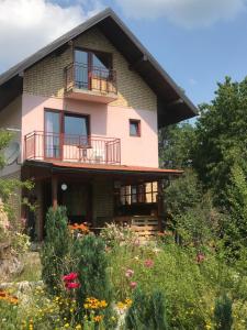 a house with a balcony and a garden at Kokin Brod Apartments in Kokin Brod
