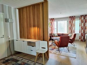 a living room with a couch and a table and chairs at Lovely cityhome in Rovaniemi
