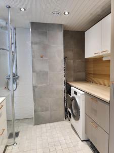 a kitchen with a washer and dryer in it at Lovely cityhome in Rovaniemi