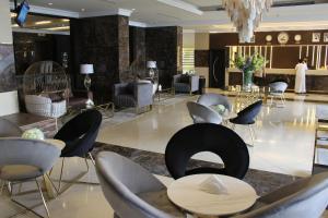 a lobby of a hotel with chairs and tables at Al Khaleej Palace Deira Hotel in Dubai