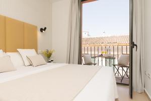 A bed or beds in a room at iloftmalaga Carretería - Puerta de Antequera