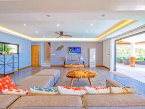 a living room with couches and a table at Villa AUREA Sea View in Koh Samui