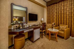 a hotel room with a vanity and a mirror at THE PARK HOTEL Formerly Al Jawhara Gardens in Dubai