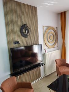 a living room with a large flat screen tv at Perea 5 star in Perea